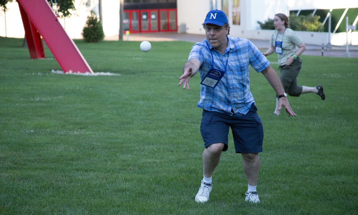 POGIL's executive director Rick Moog shows off his wiffleball pitching form.